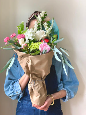 A lovely florist holding an inspiring bouquet of flowers